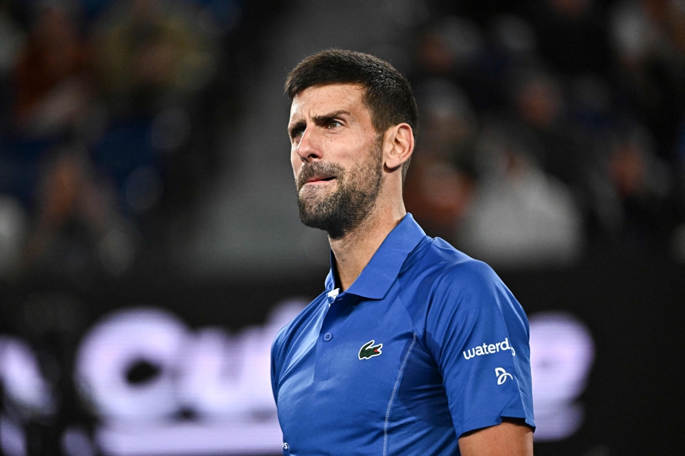 Serbia's Novak Djokovic reacts on a point against Australia's Alexei Popyrin in Melbourne on January 17, 2024. (Photo by Lillian Suwanrumpha / AFP) 
