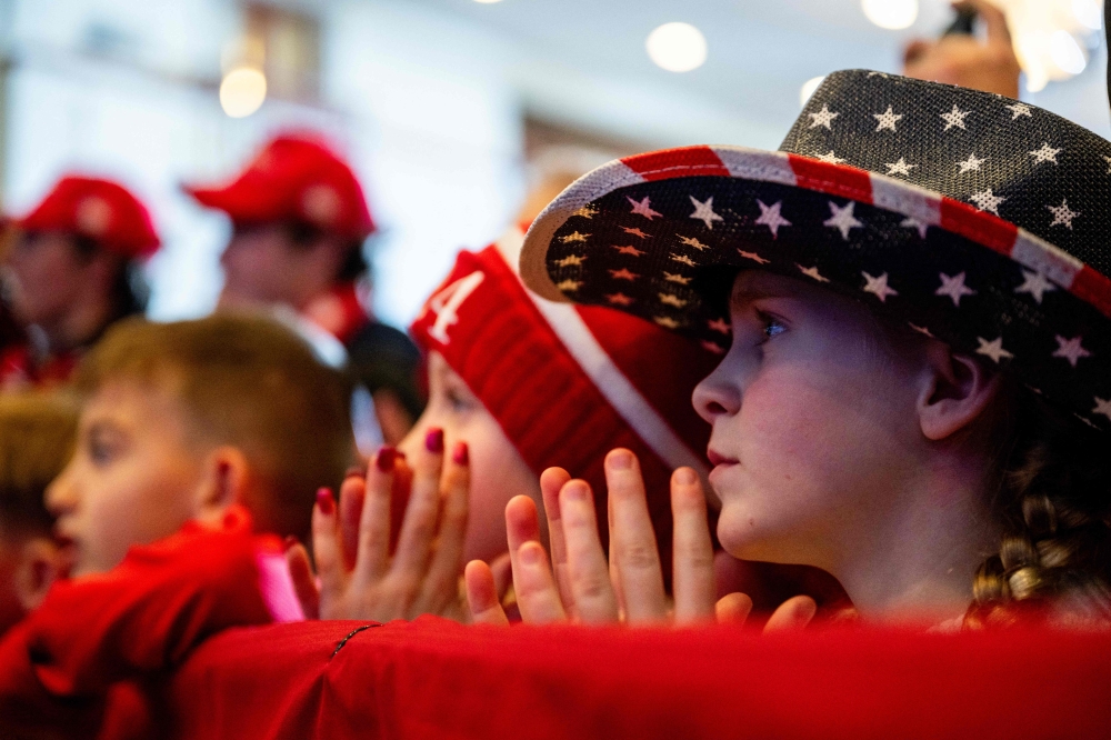 Children listen as Republican presidential candidate, former US President Donald Trump speaks during a campaign rally at the Atkinson Country Club on January 16, 2024 in Atkinson, New Hampshire. (Photo by Brandon Bell / Getty Images via AFP)
