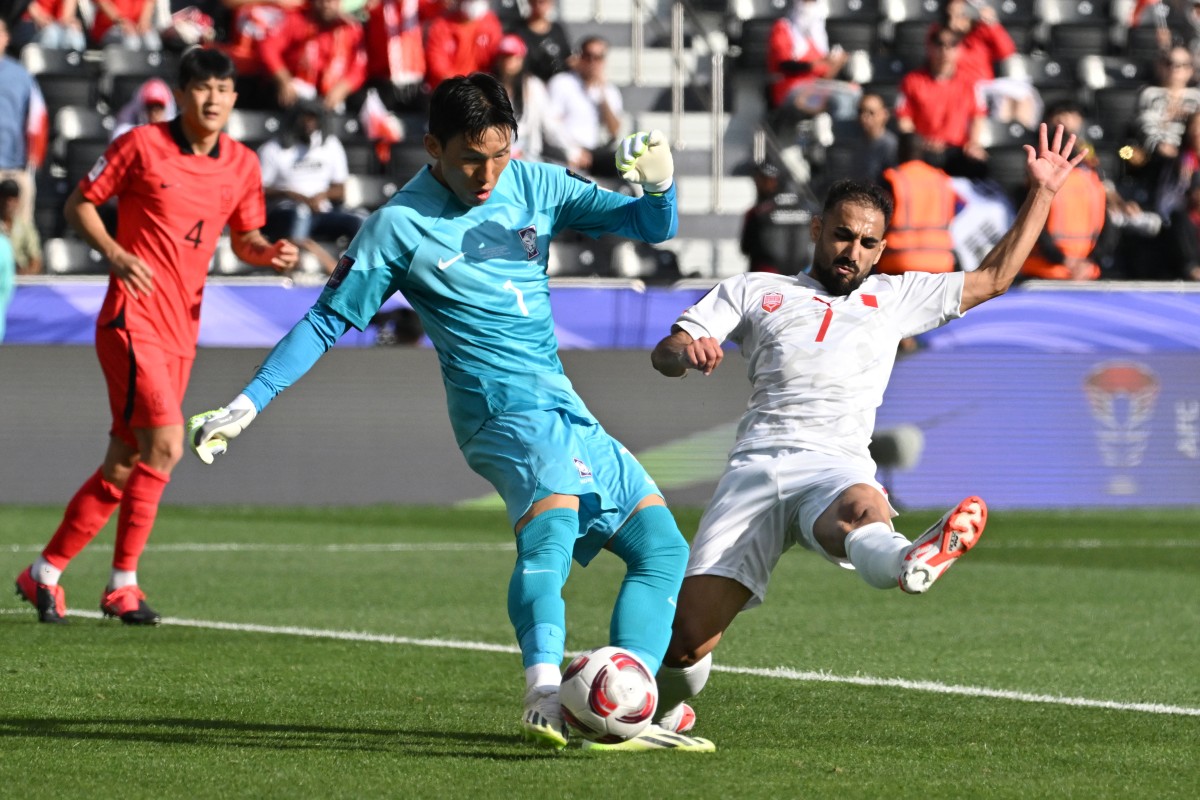 South Korea's goalkeeper #01 Kim Seung-gyu secures the ball from Bahrain's midfielder #07 Ali Madan during the Qatar 2023 AFC Asian Cup Group E football match between South Korea and Bahrain at the Jassim bin Hamad Stadium in Doha on January 15, 2024. (Photo by HECTOR RETAMAL / AFP)
