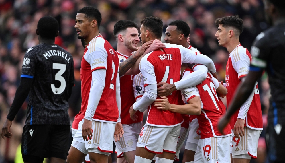 Arsenal's players celebrate their second goal scored by Crystal Palace's English goalkeeper #30 Dean Henderson (unseen) during the English Premier League football match between Arsenal and Crystal Palace at the Emirates Stadium in London on January 20, 2024. (Photo by Ben Stansall / AFP) 