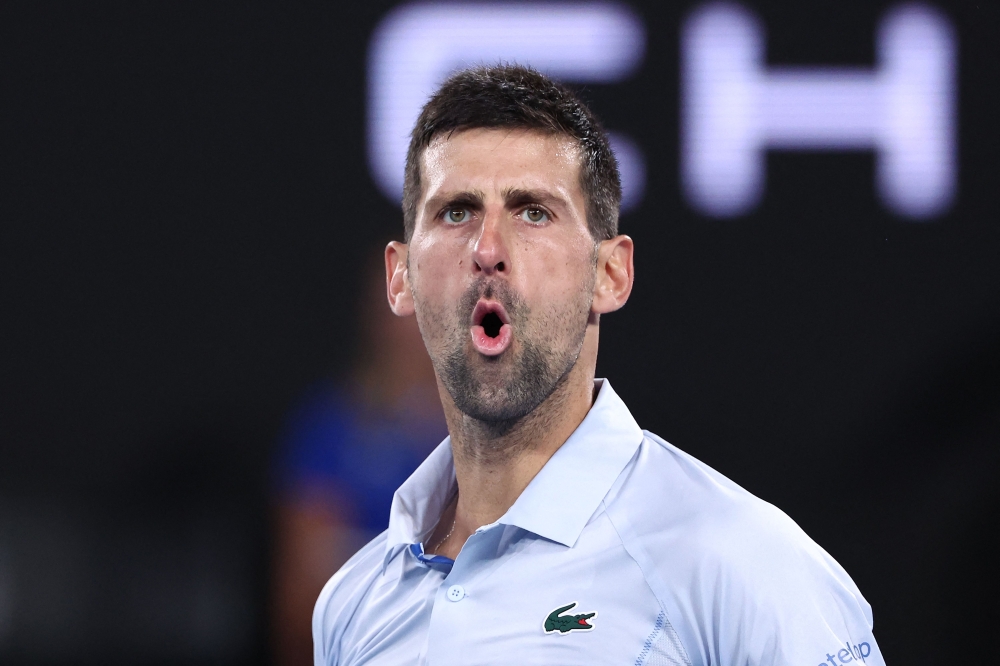 Serbia's Novak Djokovic reacts on a point against France's Adrian Mannarino during their men's singles match on day eight of the Australian Open tennis tournament in Melbourne on January 21, 2024. (Photo by David GRAY / AFP) 