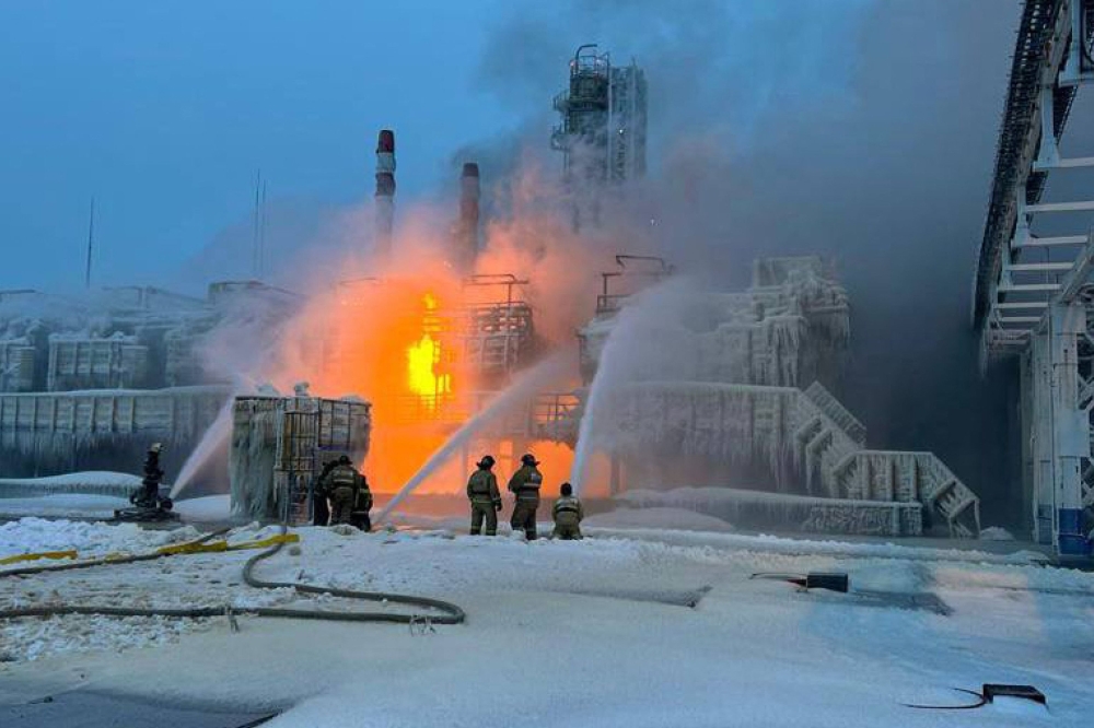 This handout photograph published on the official Telegram account of the governor of the Leningrad region Aleksandr Drozdenko on January 21, 2024, shows rescuers working to extinguish a fire at a natural gas terminal in the Russian Baltic Sea port of Ust-Luga. Photo by Handout / Telegram / @drozdenko_au_lo / AFP