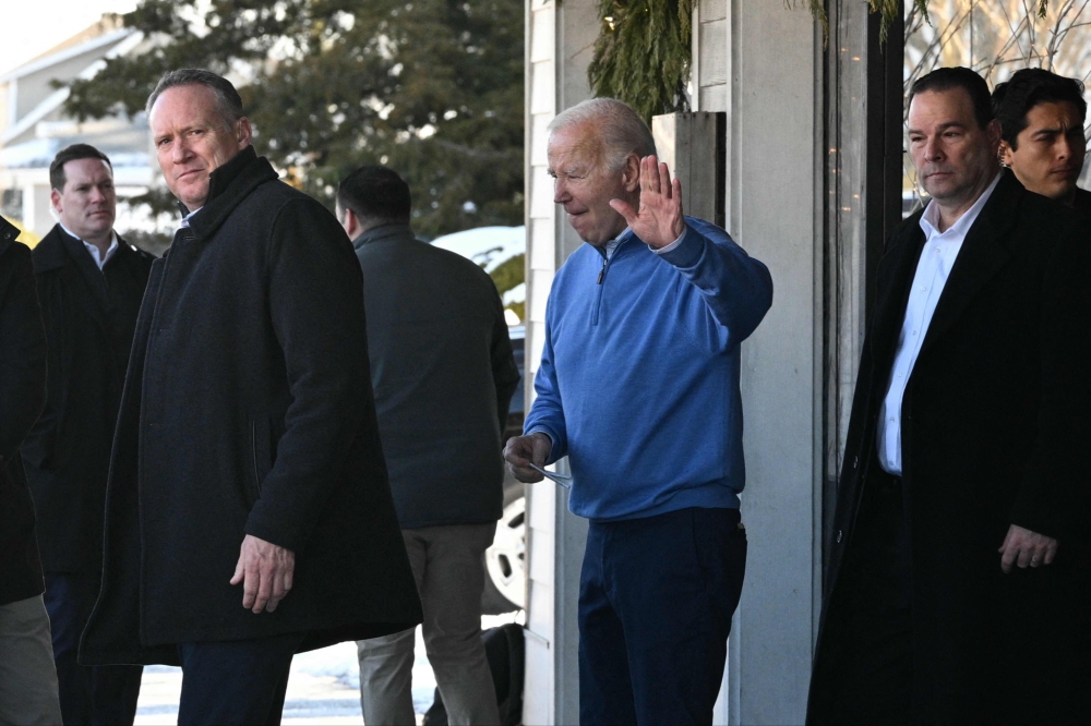 US President Joe Biden waves while stepping out of a restaurant after breakfast with First lady Jill biden (out of frame) in Rehoboth Beach, Delaware, on January 21, 2024. (Photo by Mandel NGAN / AFP)
