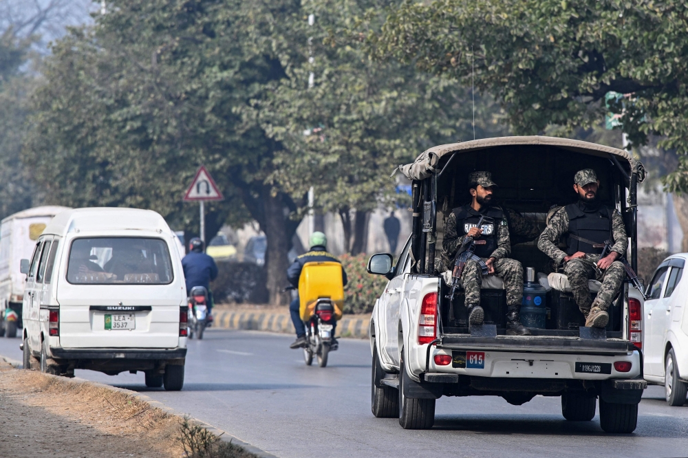 Paramilitary personnel patrolling a street ride a vehicle in Islamabad on January 22, 2024. (Photo by Farooq Naeem / AFP)