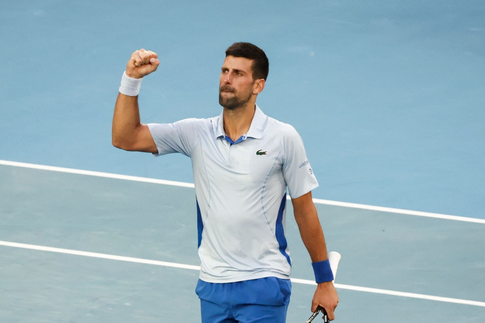 Serbia's Novak Djokovic celebrates after victory against USA's Taylor Fritz during their men's singles quarter-final match on day 10 of the Australian Open tennis tournament in Melbourne on January 23, 2024. (Photo by David Gray / AFP) 