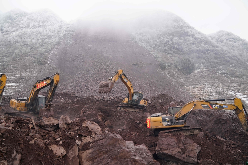 Rescue workers search for missing people at the site of a landslide in Zhaotong, in southwest China's Yunnan province on January 24, 2024. (Photo by CNS / AFP)