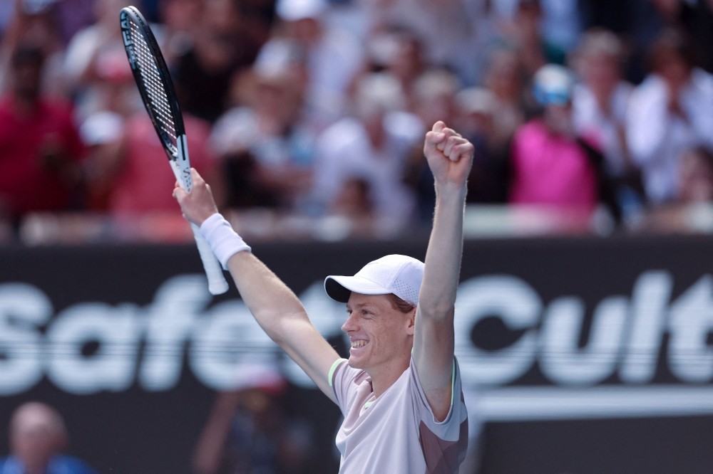 Italy's Jannik Sinner celebrates after victory against Serbia's Novak Djokovic in Melbourne on January 26, 2024. (Photo by Martin Keep / AFP)