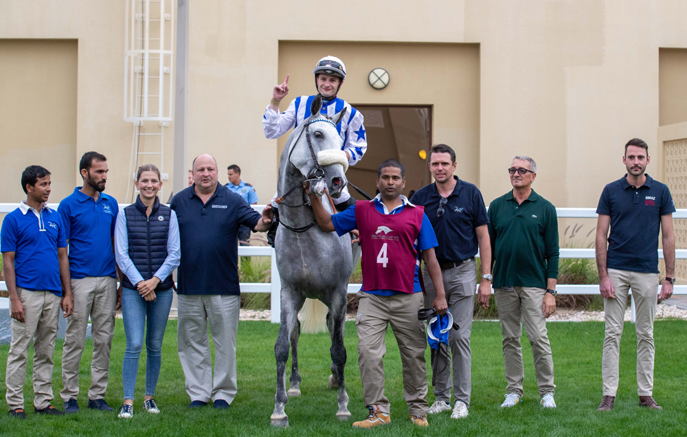 The connections of Dawi celebrate after the win. 
