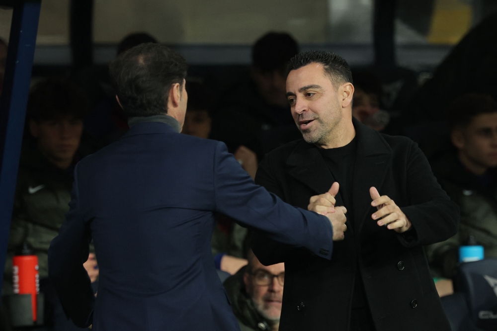 Barcelona's Spanish coach Xavi greets Villarreal's Spanish coach Marcelino Garcia Toral before the start of the Spanish league football match on January 27, 2024. (Photo by Lluis Gene / AFP)