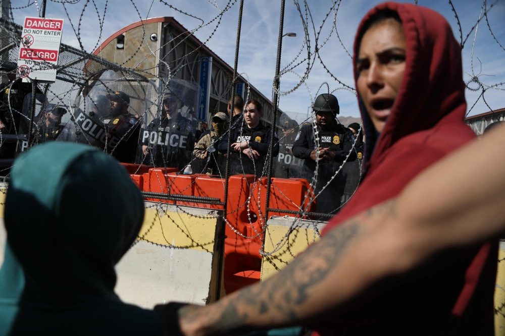Migrants, mostly of Venezuelan origin, attempt to forcibly cross into the United States at the Paso del Norte International Bridge in Ciudad Juarez, Chihuahua state, Mexico, on March 12, 2023. (Photo by Herika Martinez / AFP)