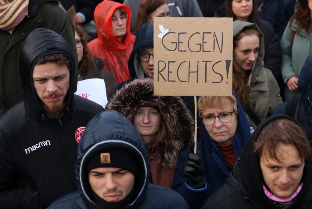 Demonstrators protest against the far-right Alternative for Germany (AfD) party outside the Reichstag building in Berlin, Germany on February 3, 2024, during a rally under the motto 'We are the firewall' called for by international non-profit organisation 'Hand in Hand' to protest against right-wing politics. (Photo by Adam BERRY / AFP)
