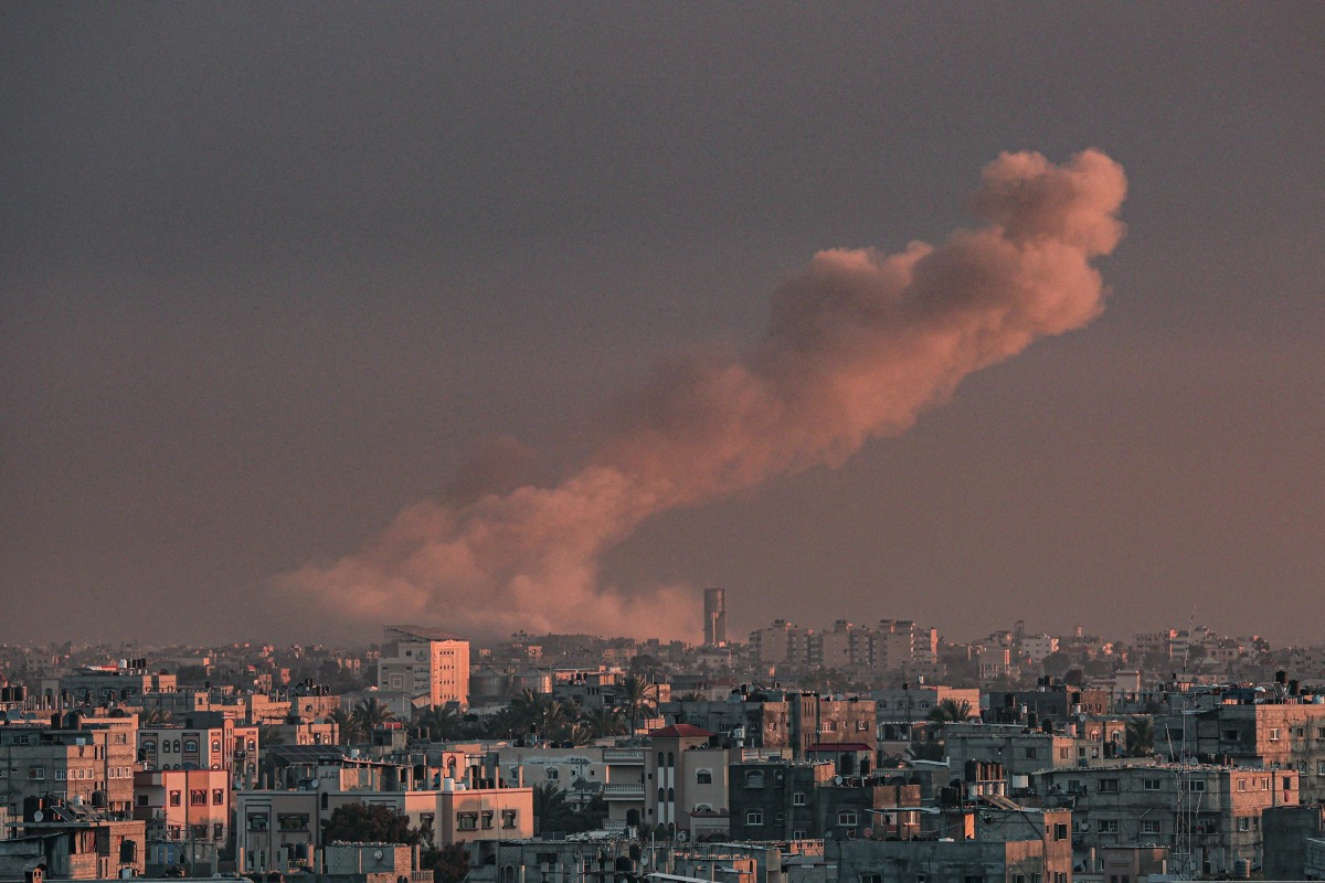  A picture taken from Rafah in the southern Gaza Strip shows smoke rising over buildings in Khan Yunis following Israeli bombardment on February 5, 2024. (Photo by Said KHATIB / AFP)
