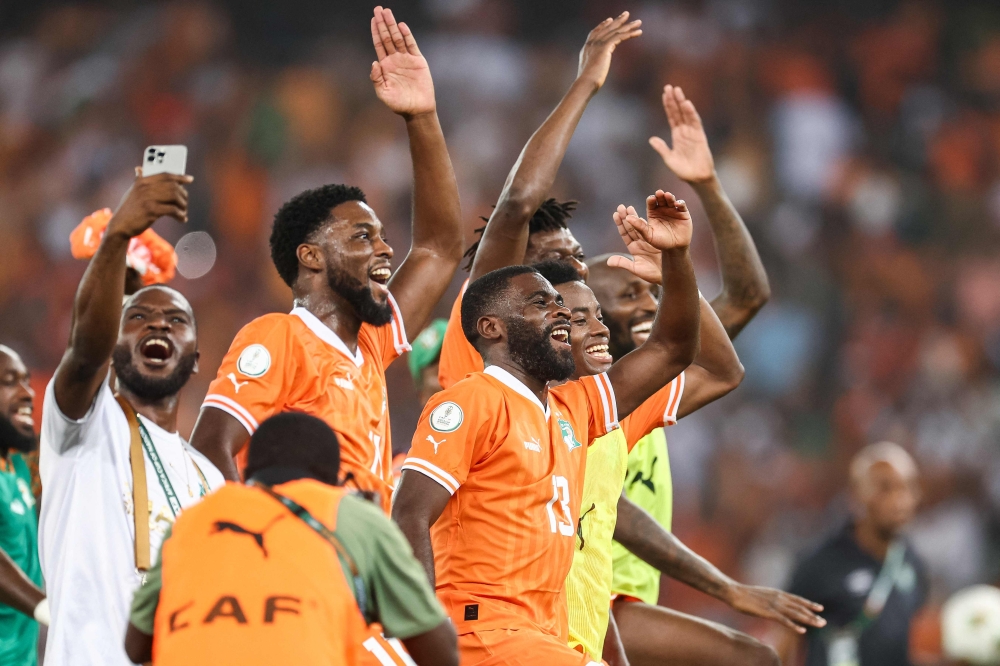 Ivory Coast's players celebrate after winning at the end of the Africa Cup of Nations (CAN) 2024 semi-final football match at Alassane Ouattara Olympic Stadium in Ebimpe, Abidjan on February 7, 2024. (Photo by Franck Fife / AFP)
