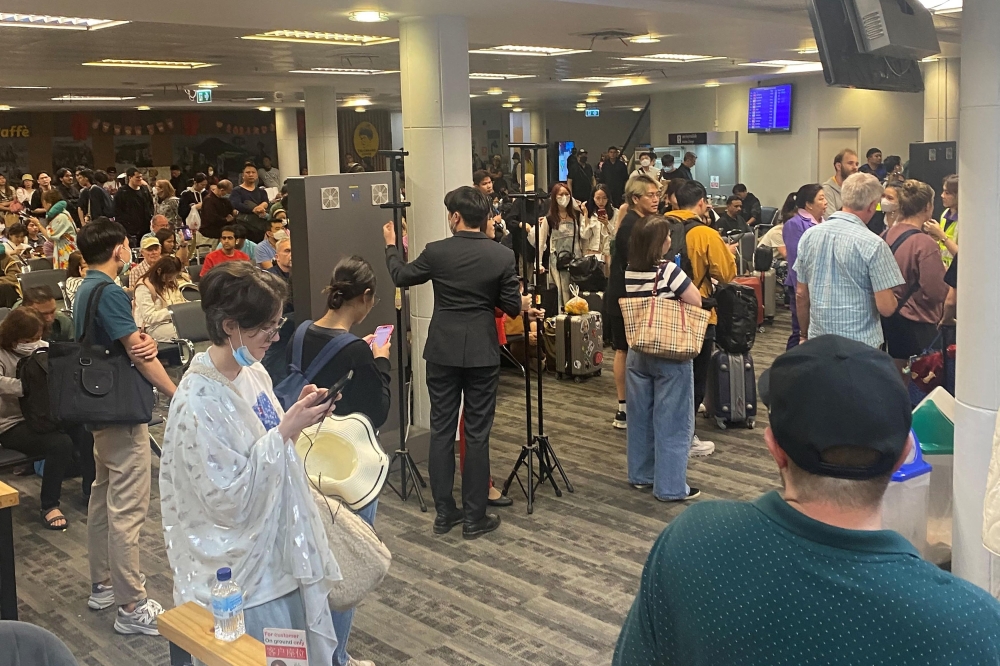 This UGC photo taken on February 7, 2024 and posted by Facebook user Watcharapon Pethsurp on February 9 shows passengers waiting at Chiang Mai Airport in Chiang Mai, after disembarking their flight following a passenger's attempt to open an emergency exit door. Photo by Courtesy of Facebook user Watcharapon Pethsurp / AFP
