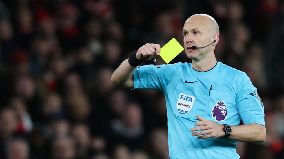 File: Premier League referee Anthony Taylor shows a yellow card. (Adrian Dennis / AFP)