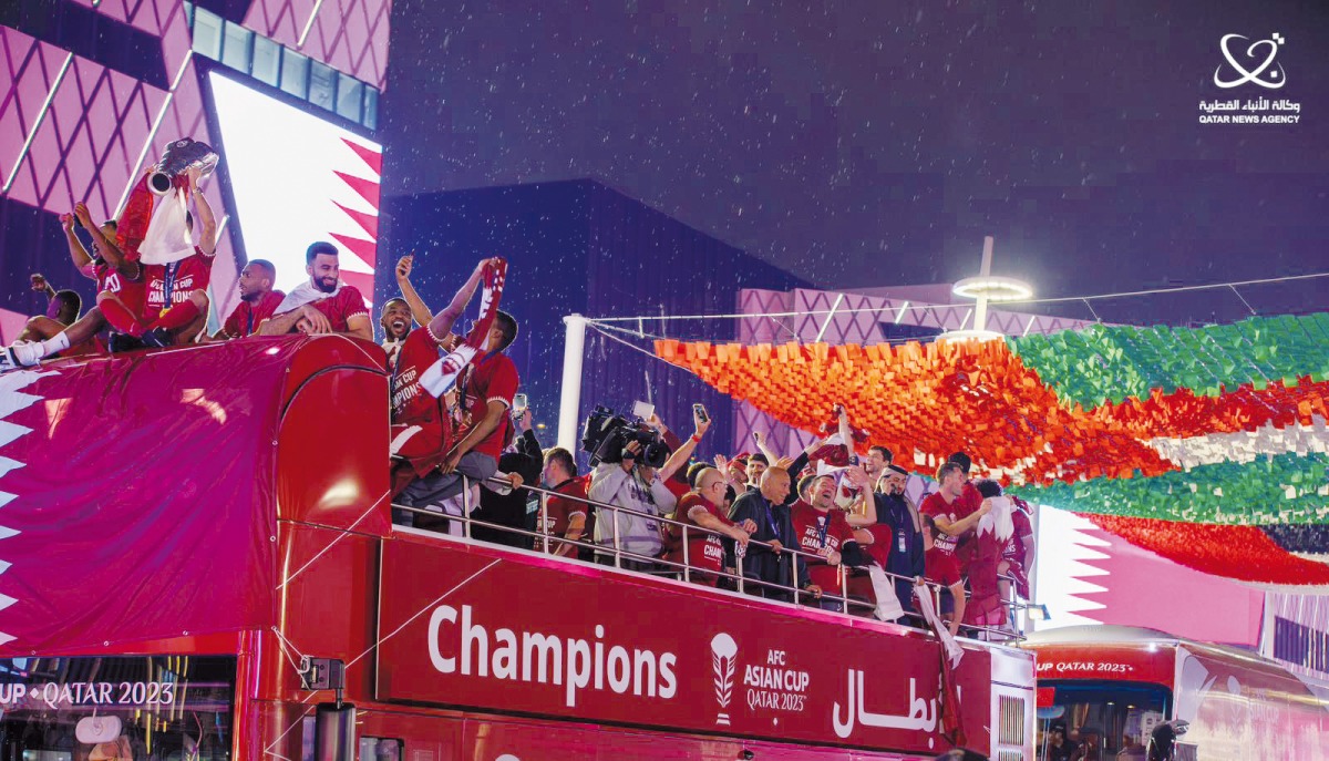 Qatar players and officials celebrate during the victory parade at the Lusail Boulevard. 