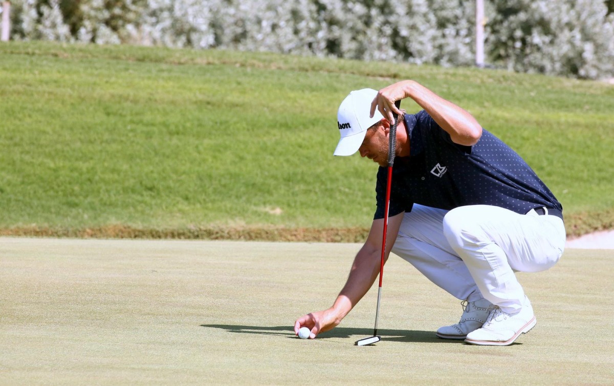 Ugo Coussaud prepares to putt in the third round of the Commercial Bank Qatar Masters at the Doha Golf Club, yesterday. 
