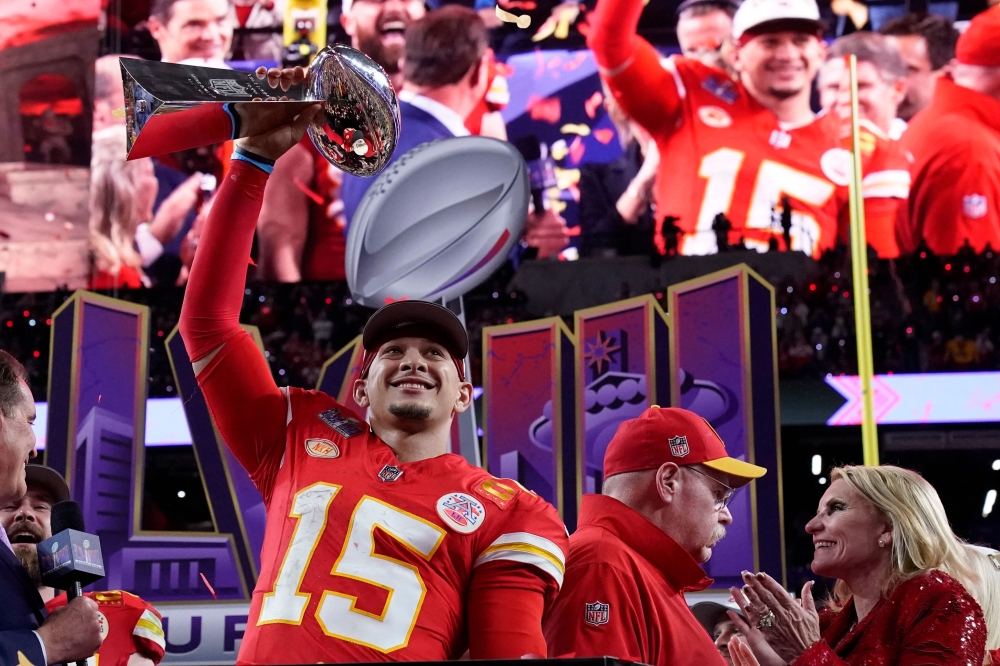 Kansas City Chiefs' quarterback #15 Patrick Mahomes celebrates with the trophy after the Chiefs won Super Bowl LVIII against the San Francisco 49ers at Allegiant Stadium in Las Vegas, Nevada, February 11, 2024. (Photo by TIMOTHY A. CLARY / AFP)
