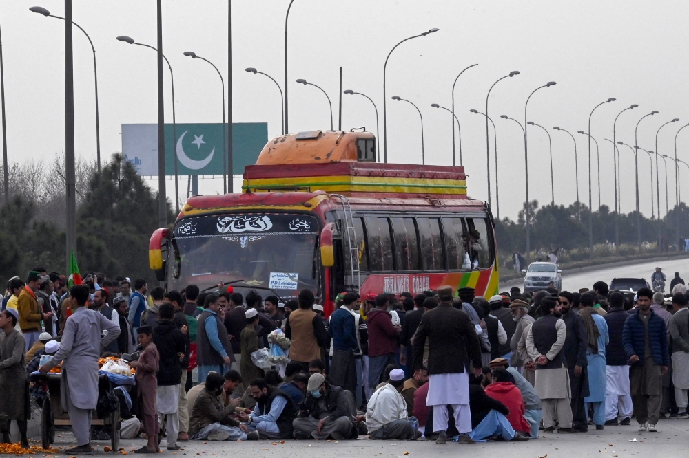 Supporters of Khan's Pakistan Tehreek-e-Insaf (PTI) party block Peshawar to Islambad highway as they protest against the alleged skewing in Pakistan's national election results, in Peshawar on February 12, 2024. (Photo by Abdul MAJEED / AFP)
