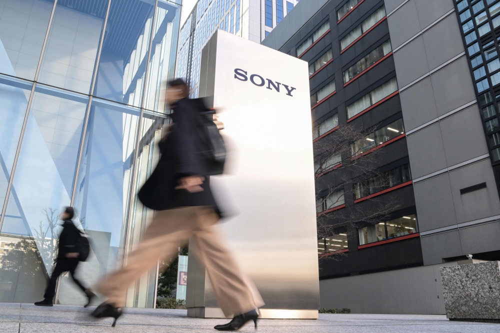 People walk into the headquarters of the Sony Group Corporation in Tokyo on February 14, 2024. Photo by Richard A. Brooks / AFP