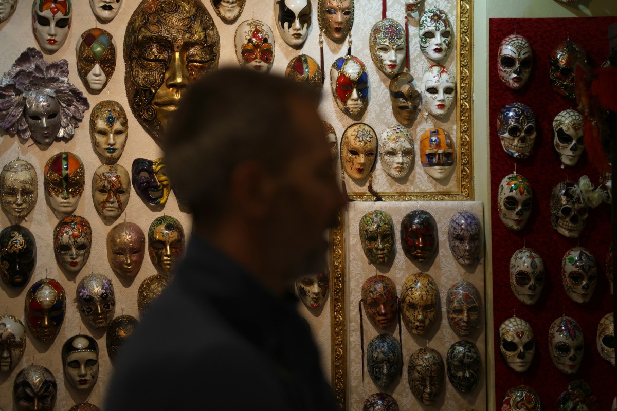 Edmond Angoni, the owner and leading artist behind the Venice Art Mask Factory, gives an interview in his workshop in Shkoder, on February 7, 2024, as more than two dozen craftsmen in a quaint studio in northern Albania put the final touches on a series of elegant Venetian masks destined for balls, film sets, and street parties. Photo by Adnan Beci / AFP