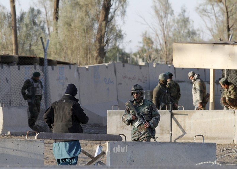File photo of Afghan security forces stand guard at the entrance gate of Kandahar Airport 