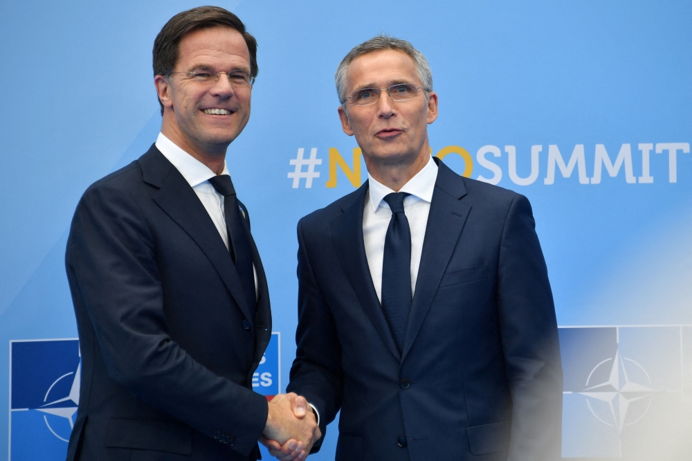 File: Netherland's Prime Minister Mark Rutte (left) shakes hands with NATO Secretary General Jens Stoltenberg during the NATO (North Atlantic Treaty Organization) summit, at the NATO headquarters in Brussels, on July 11, 2018.  (Photo by Denis Charlet / AFP)
