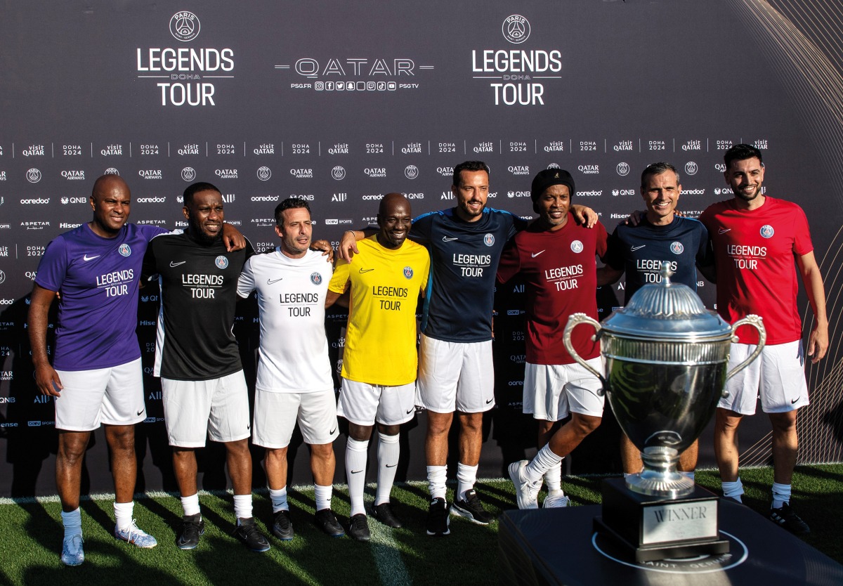 Former Paris Saint-Germain stars pose with the winner's trophy ahead of the Legends Tour by Visit Qatar, in Doha.