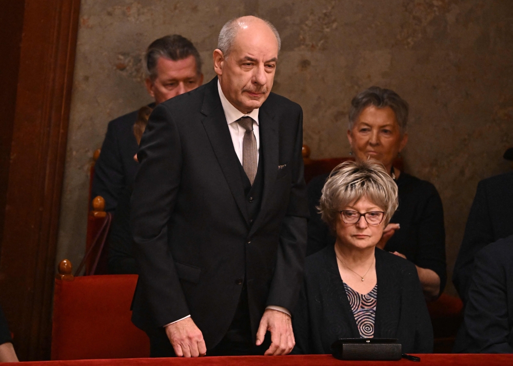 The former chairman of the Constitutional Court Tamas Sulyok (left) is presented to representatives of the Hungarian Parliament in the main hall of the parliament building in Budapest on February 26, 2024. (Photo by Attila Kisbenedek / AFP)