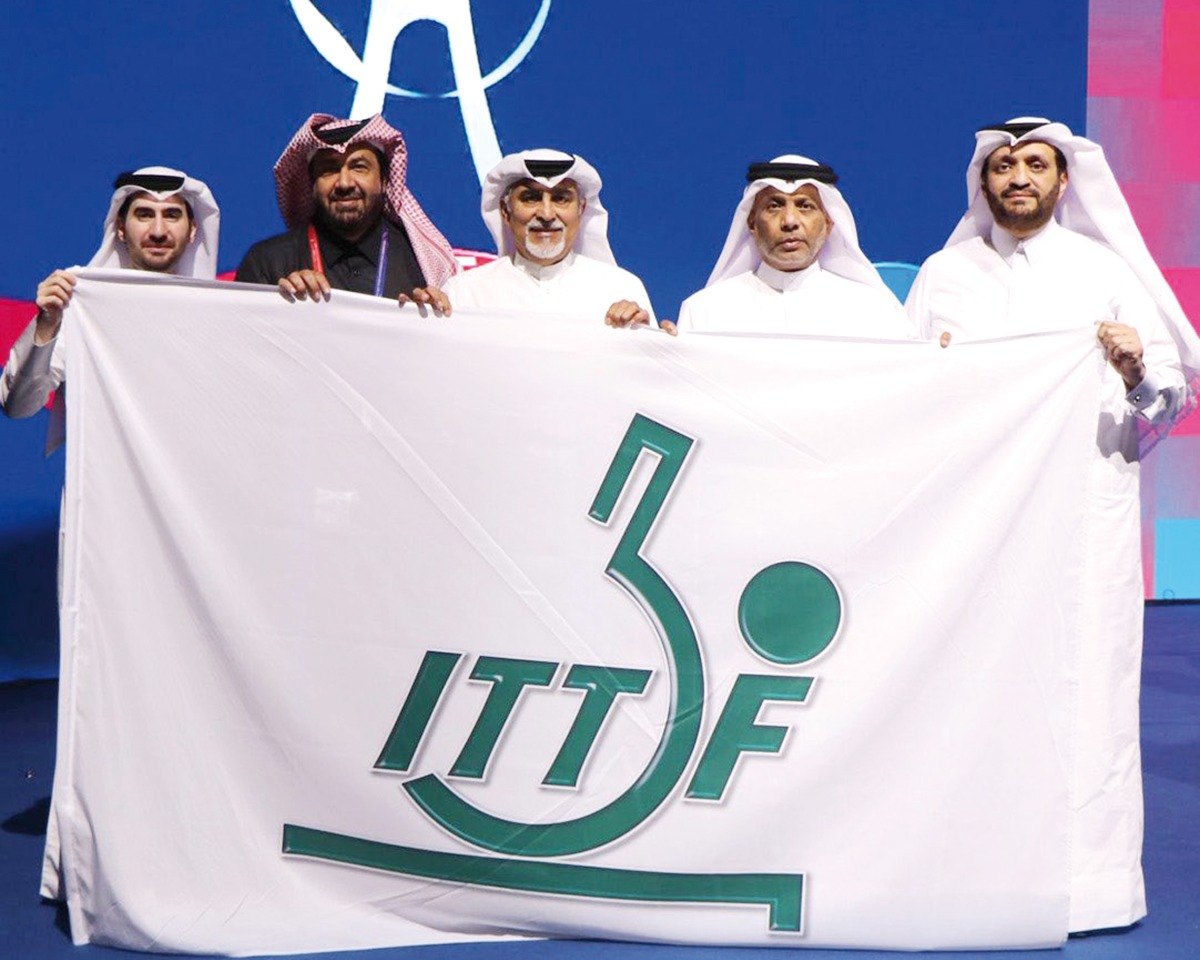 QTAA President Khalil Al Mohannadi (second right)  and members of Qatar delegation pose for a photo after receiving the flag.   