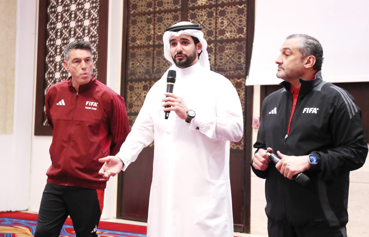 QFA Secretary-General Mansour Al Ansari speaks during the opening ceremony of FIFA seminar yesterday. QFA Arbitration Department Hani Taleb Ballan (right) and FIFA Arbitration Department Executive Director Massimo Busacca are also present.   
