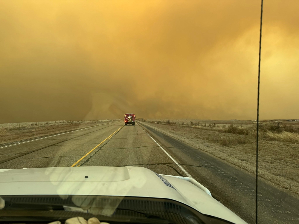 This handout picture courtesy of the Flower Mound Fire Department taken on February 27, 2024, shows a fire truck driving towards the Smokehouse Creek Fire, near Amarillo, in the Texas Panhandle. Photo by Flower Mound Fire Department / AFP