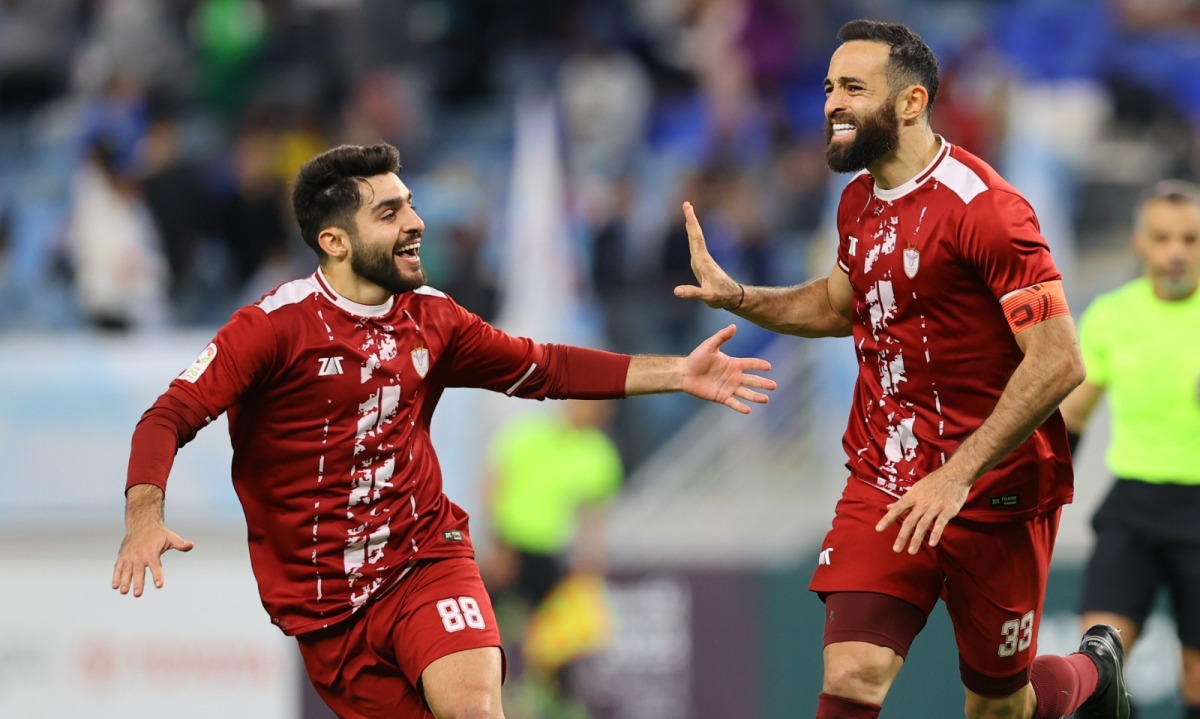 Al Markhiya’s Driss Fettouhi (right) celebrates with Mohamad Al Abbasi after scoring a goal against Al Wakrah at the Al Janoub Stadium, yesterday. 