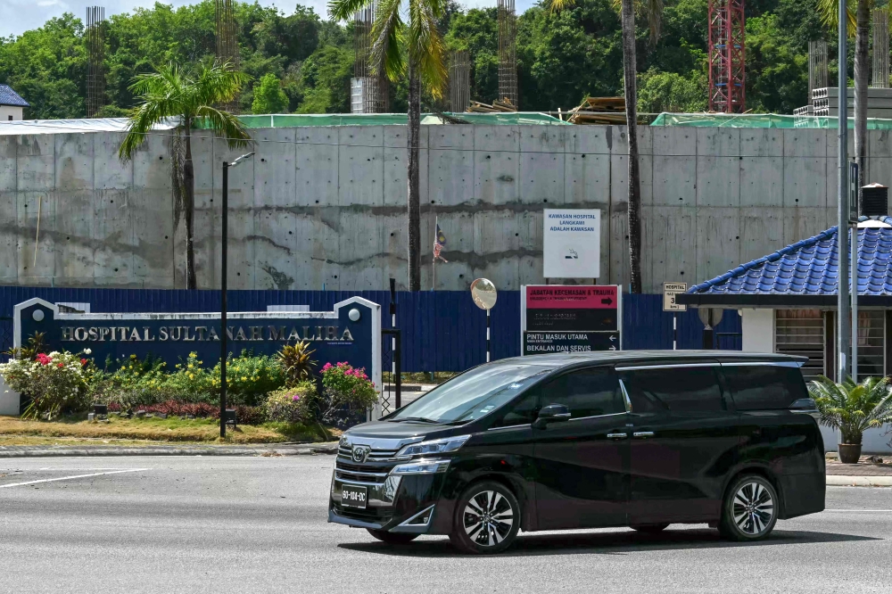 A vehicle with a diplomatic license plate drives out from Sultanah Maliha Hospital, where Norway's King Harald V has been admitted with an infection, on the Malaysian resort island of Langkawi on March 1, 2024. (Photo by MOHD RASFAN / AFP)
