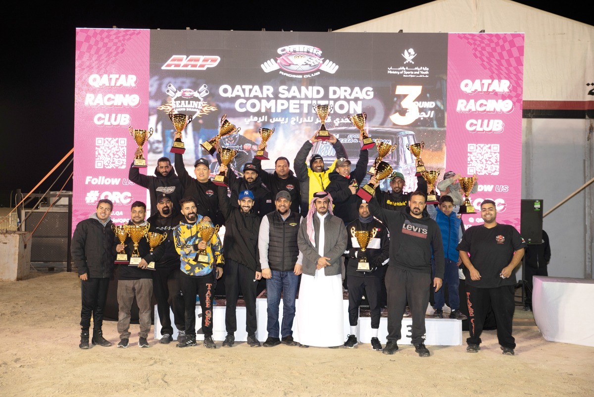 QRC Director Sheikh Jabor bin Khalid Al Thani with the podium winners during the third and penultimate round of the Sealine Qatar Sand Drag Competition.