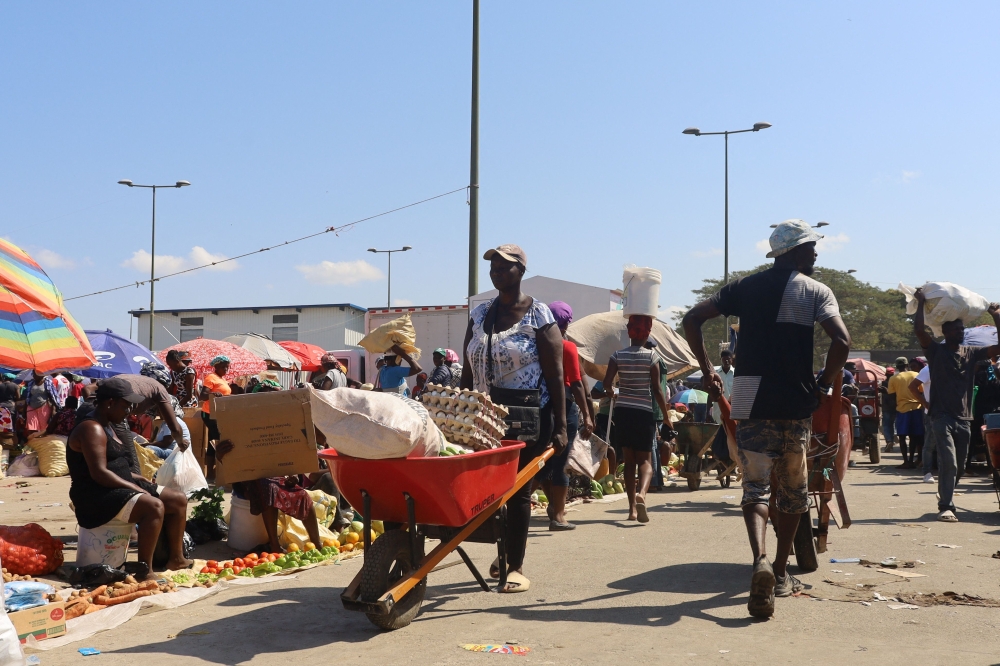 Haitian citizens take part in the Dajabon border market at the Dominican Republic-Haiti border, as seen from Dajabon, Dominican Republic on March 8, 2024. (Photo by Erickson Polanco / AFP)