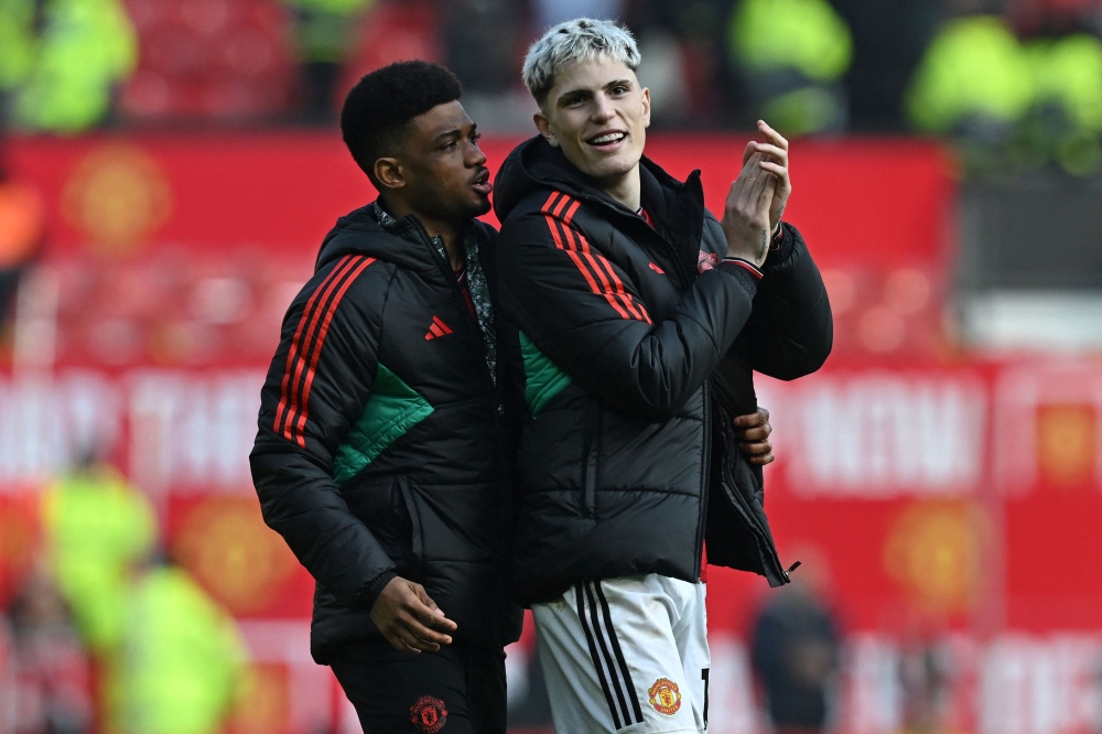 Manchester United's Ivorian midfielder #16 Amad Diallo (L) and Manchester United's Argentinian midfielder #17 Alejandro Garnacho (R) celebrate on the pitch after the English Premier League football match between Manchester United and Everton at Old Trafford in Manchester, north west England, on March 9, 2024. (Photo by Paul ELLIS / AFP)