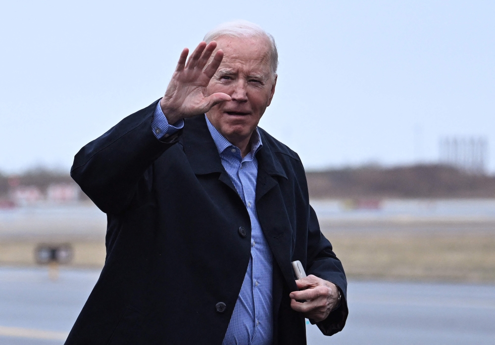 US President Joe Biden waves as he arrives to board Air Force One at Philadelphia International Airport in Philadelphia, Pennsylvania, on March 9, 2024. (Photo by Jim WATSON / AFP)
