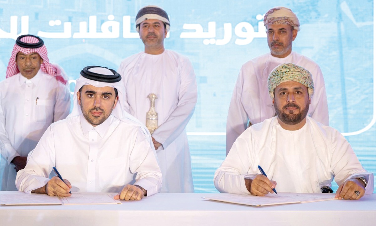 Ambassador of Qatar to Oman H E Sheikh Mubarak bin Fahad Al Thani (back left) with Karwa Motors and Omani officials during the agreement signing ceremony. 