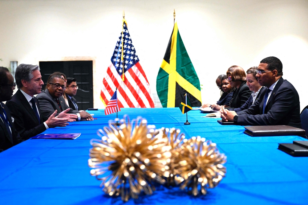 US Secretary of State Antony Blinken (L) speaks during a bilateral meeting with Jamaican Prime Minister Andrew Holness (R) at the Pegasus Hotel ahead of the emergency meeting on Haiti at the Conference of Heads of Government of the Caribbean Community (CARICOM) in Kingston, Jamaica, on March 11, 2024. (Photo by Andrew Caballero-Reynolds / POOL / AFP)

