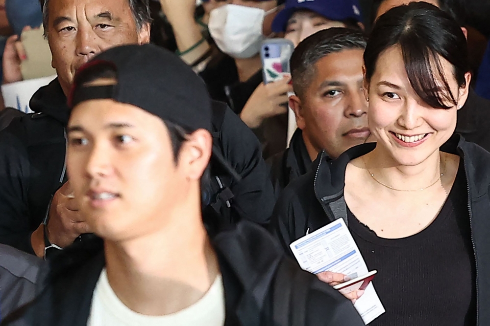 Mamiko Tanaka (R), wife of Los Angeles Dodgers Shohei Ohtani (L), arrives with the baseball team's players at Incheon International Airport in Incheon on March 15, 2024, ahead of the 2024 MLB Seoul Series baseball games between Los Angeles Dodgers and San Diego Padres. Photo by YONHAP / AFP