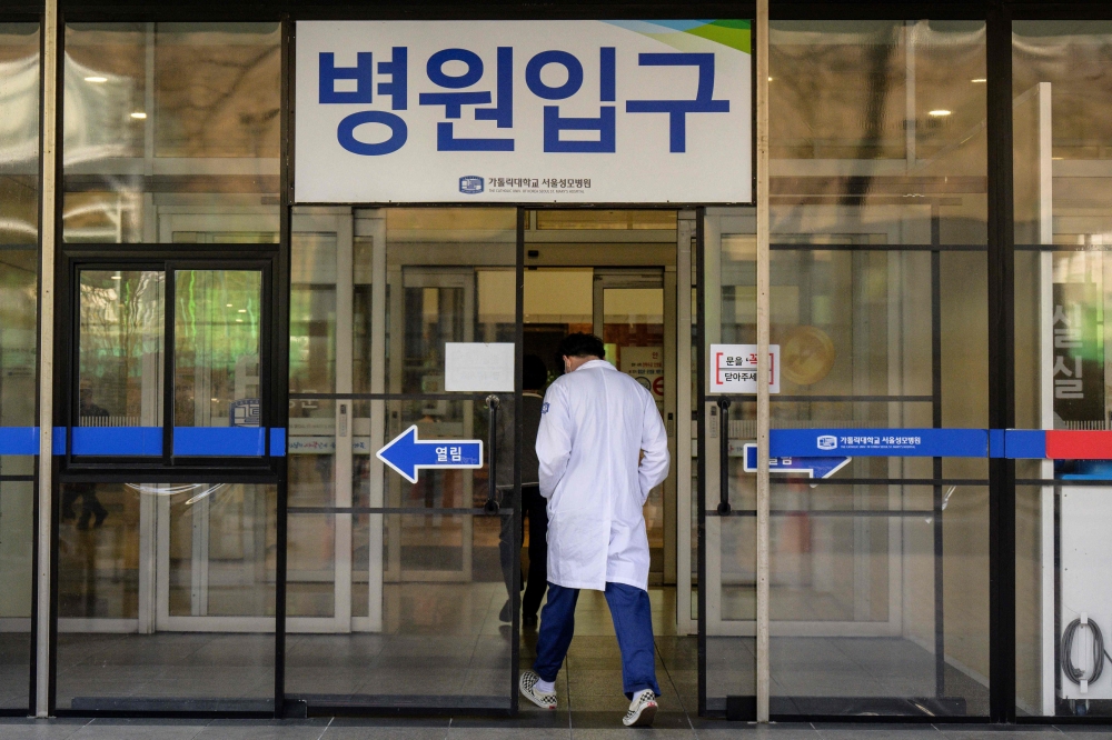 A medical worker walks into a hospital in Seoul on March 15, 2024. Photo by ANTHONY WALLACE / AFP