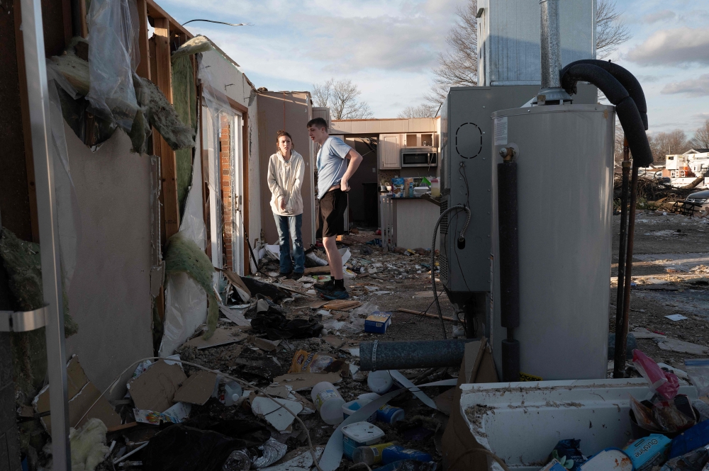 Residents clean up after a tornado ripped through town on March 15, 2024 in Winchester, Indiana. At least three people have been reported killed after a series of tornadoes ripped through the midwest yesterday. (Photo by SCOTT OLSON / GETTY IMAGES NORTH AMERICA / Getty Images via AFP)
