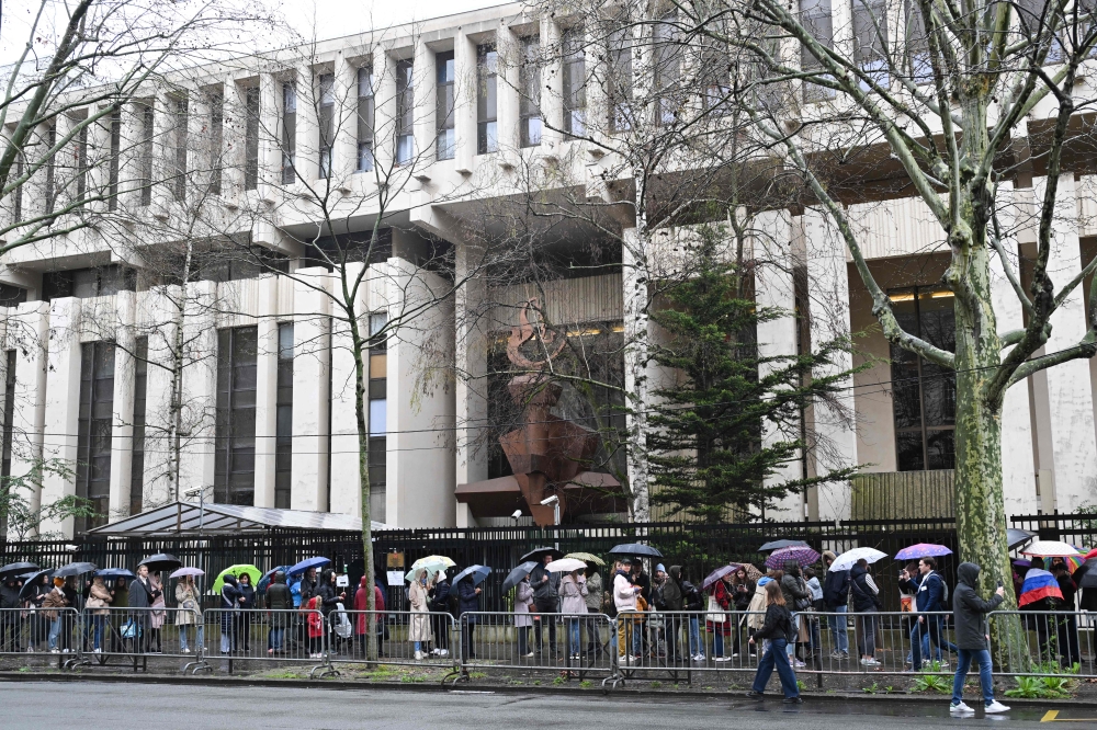 Voters queue at the Russian Embassy in France, in Paris, on March 17, 2024, during Russia's presidential election. Photo Credit: Bertrand GUAY / AFP. 