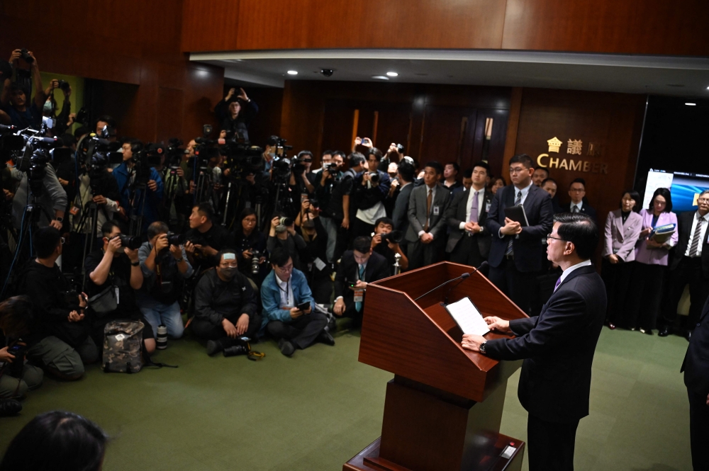 Chief Executive John Lee speaks to the media in the Legislative Council building after the passing of the Article 23 National Security Law in Hong Kong on March 19, 2024. Photo Credit: Peter PARKS / AFP.