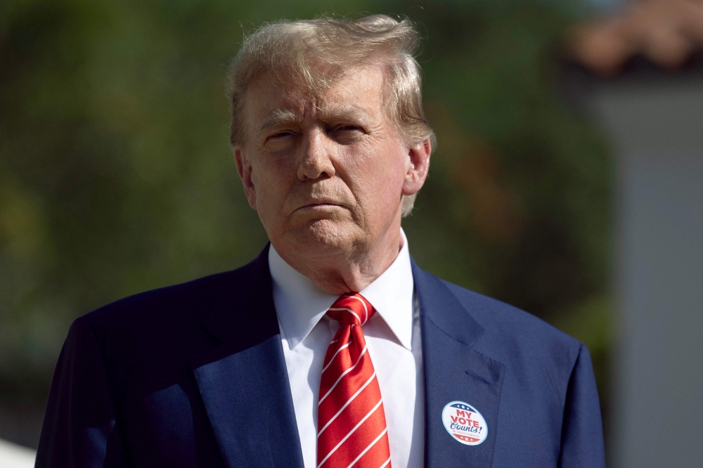 Former U.S. President Donald Trump speaks to the media after voting at a polling station setup in the Morton and Barbara Mandel Recreation Center on March 19, 2024, in Palm Beach, Florida. (Photo by JOE RAEDLE / GETTY IMAGES NORTH AMERICA / Getty Images via AFP)
