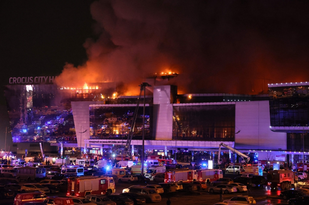Emergency services vehicles are seen outside the burning Crocus City Hall concert hall following the shooting incident in Krasnogorsk, outside Moscow, on March 22, 2024. (Photo by Stringer / AFP)