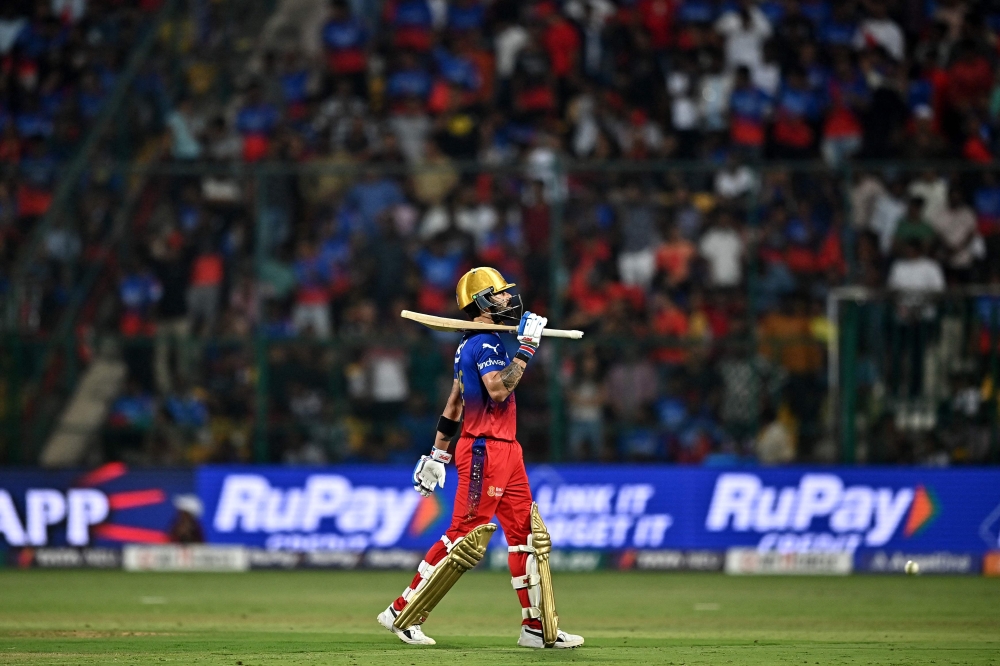 Royal Challengers Bengaluru's Virat Kohli walks back to the pavilion after his dismissal during the Indian Premier League (IPL) Twenty20 cricket match between Royal Challengers Bengaluru and Punjab Kings at the M. Chinnaswamy Stadium in Bengaluru on March 25, 2024. (Photo by Idrees MOHAMMED / AFP)