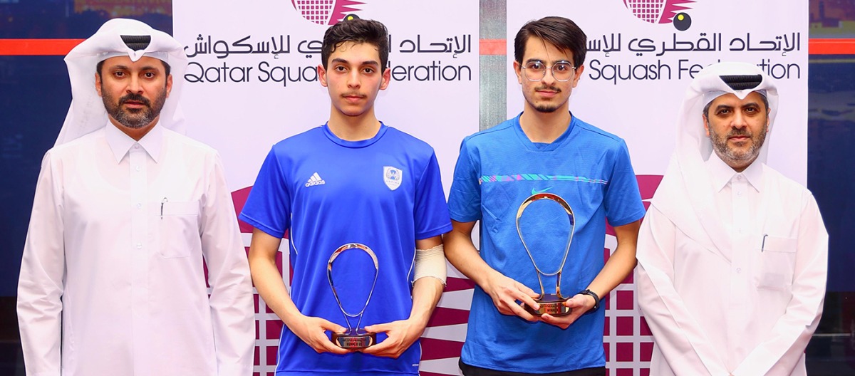 Secretary General of the Qatar Tennis, Squash, Padel and Badminton Federation Tareq Zainal (right) and Tournament Director Saad Al Mohannadi (left) with the finalists of PSA 2 QSF Satellite 2024 Tournament.