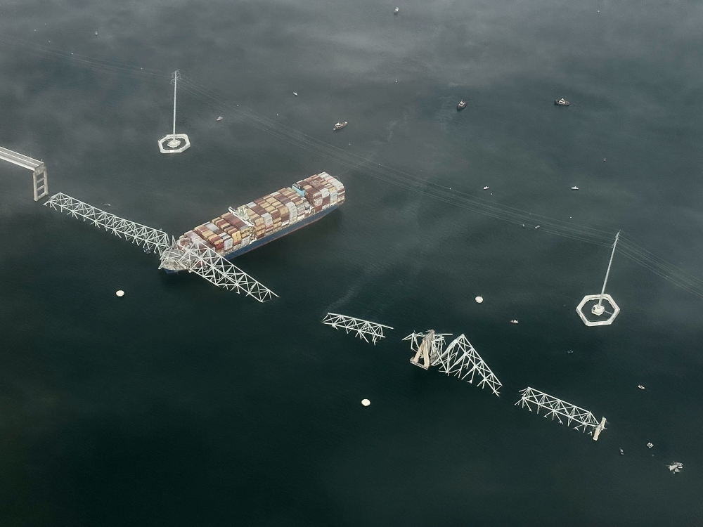 A view of the Singapore-flagged container vessel Dali and the collapse of Francis Scott Key Bridge. Photo by Carolyn Van Houten / The Washington Post. 